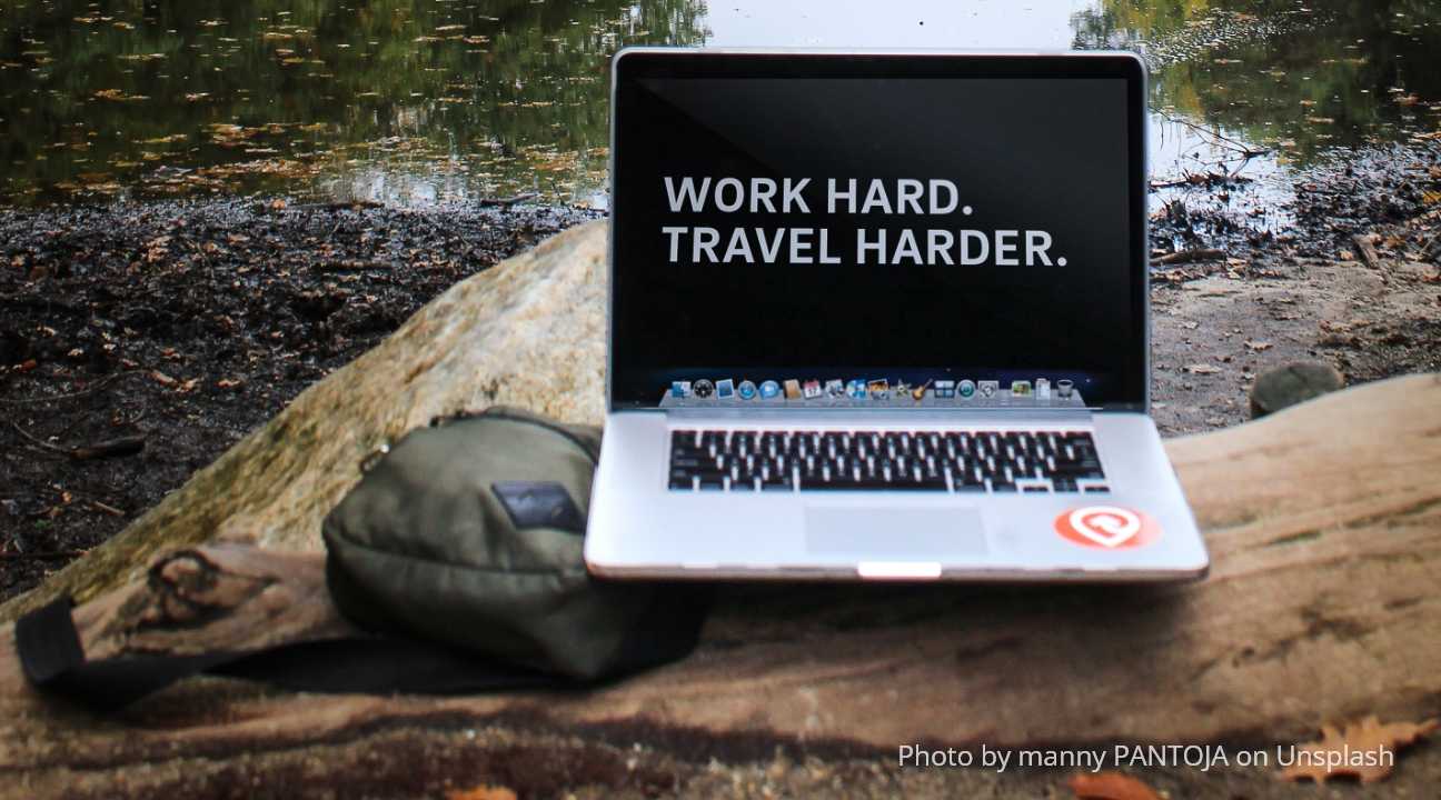 travel backpacks - a carry-on backpack and a Macbook outdoors