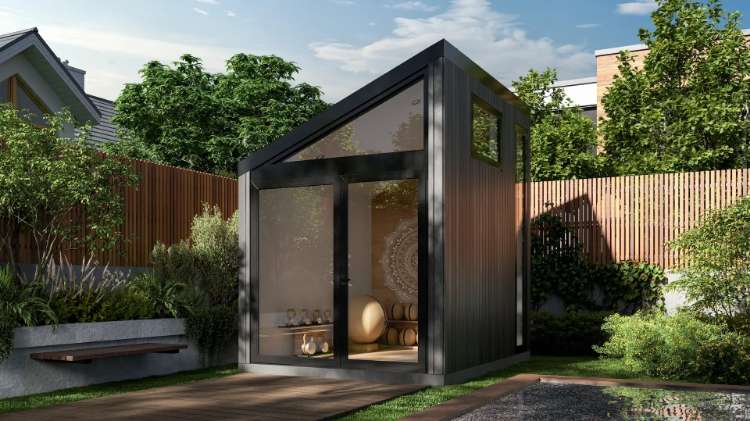 Cerca Homes Sela Mini Prefab Outdoor 80 square feet office pod placed in a small outdoor garden space in daylight