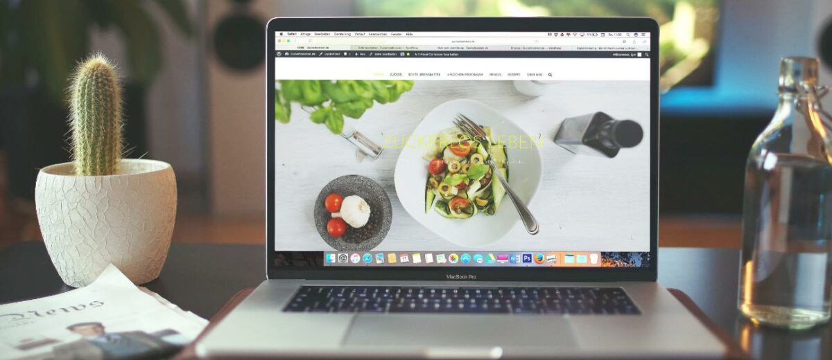 A Mackbook displaying a website landing page with a large image of a dish of salad