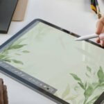 an llustrator doing green botanical drawing on the iPad with a digital stylus